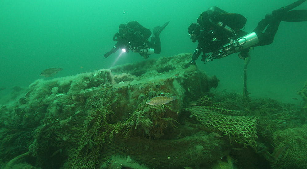 divers examining a shipwreck