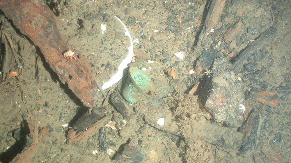 A bell among other debris on the seafloor