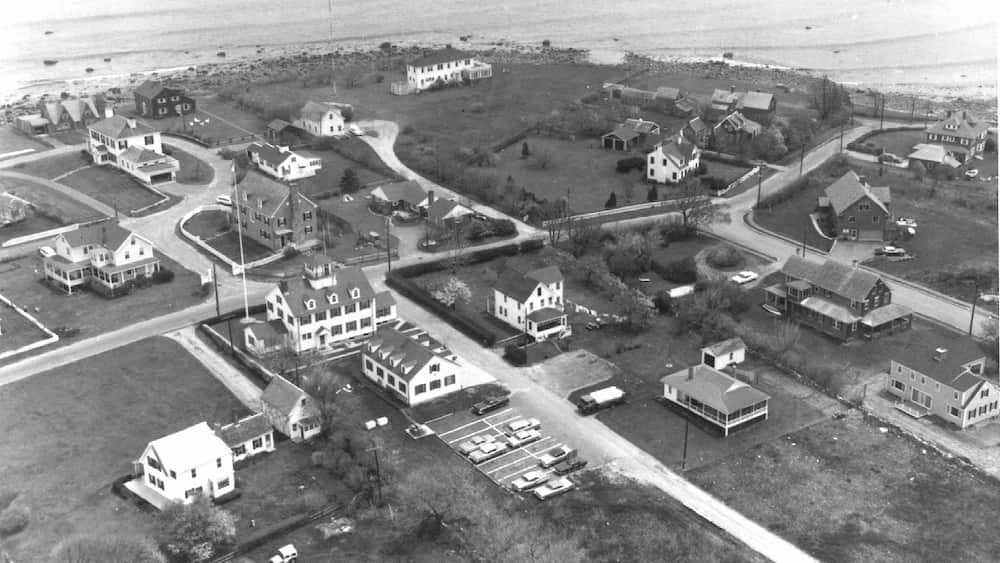 An aerial view circa 1950 shows the Coast Guard Station's main building