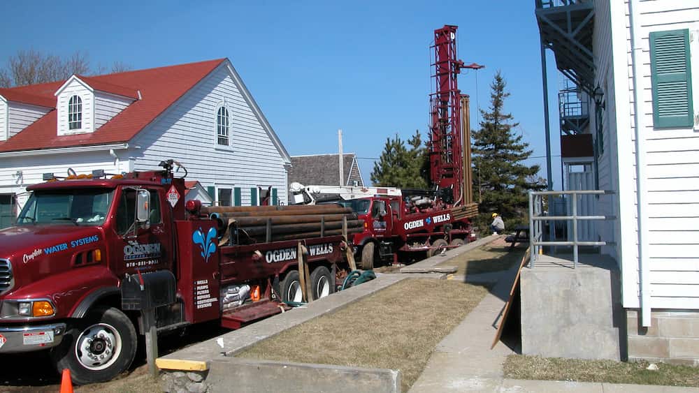 Trucks installing a geothermal HVAC system 