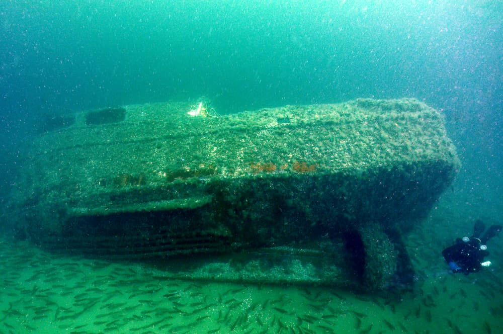 A diver next to a shipwreck